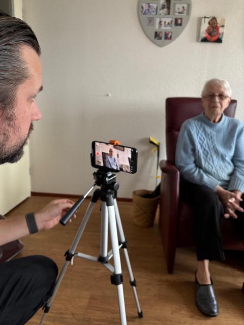 Founder recording a grandmother interview on a phone